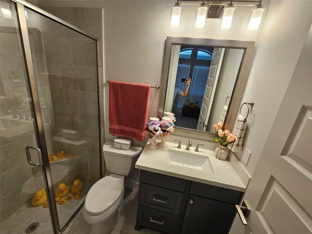 a spacious bathroom with a tub sink shower and mirror