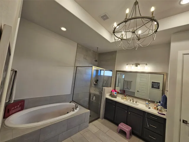 a bathroom with a bathtub and a shower