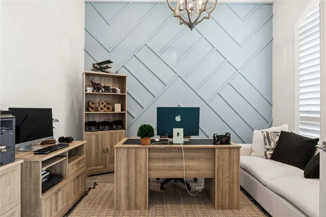 a living room with furniture a flat screen tv and kitchen view