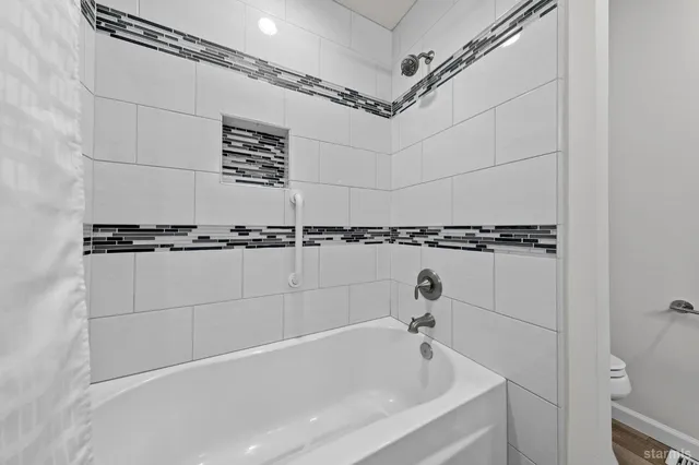 a bathroom with a bathtub and shower