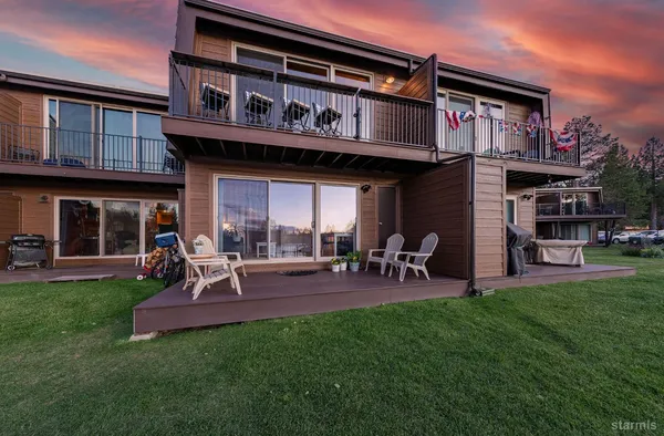 a view of a house with a yard porch and sitting area