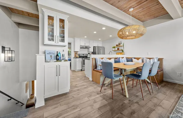a kitchen with granite countertop a sink and white cabinets