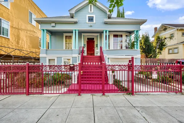 a view of a house with wooden fence