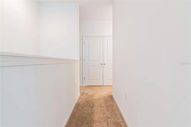 a white toilet sitting next to a sink and vanity