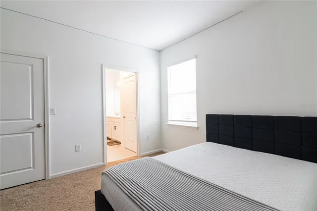 a spacious bathroom with a double vanity sink a mirror and a bathtub