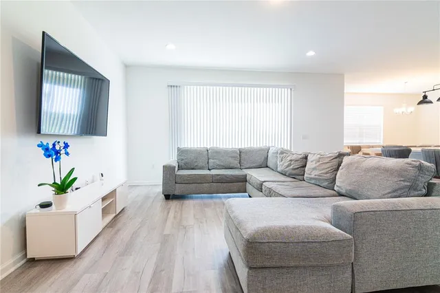 a living room with couches and a flat screen tv