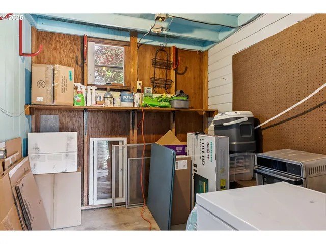 a kitchen view of a fireplace a window and a counter