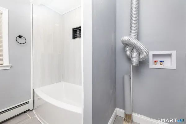 a bath tub sitting next to a white sink