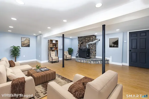 a living room with furniture and wooden floor