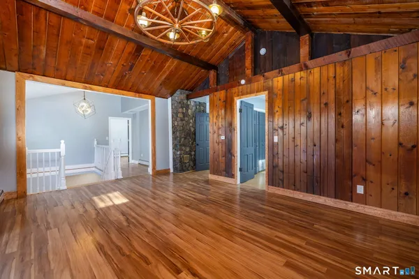 a view of an empty room with wooden floor