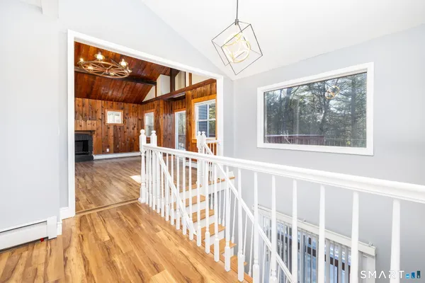 a view of a porch with wooden floor and windows