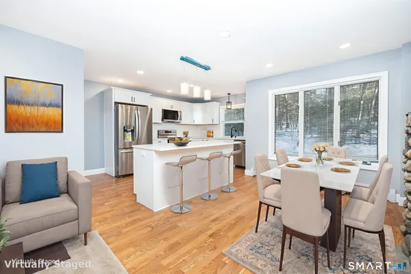 a living room with kitchen island furniture and a kitchen view