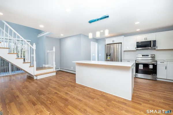 a view of kitchen with microwave and cabinets
