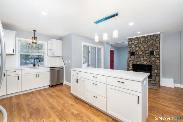 a kitchen with white cabinets and white appliances