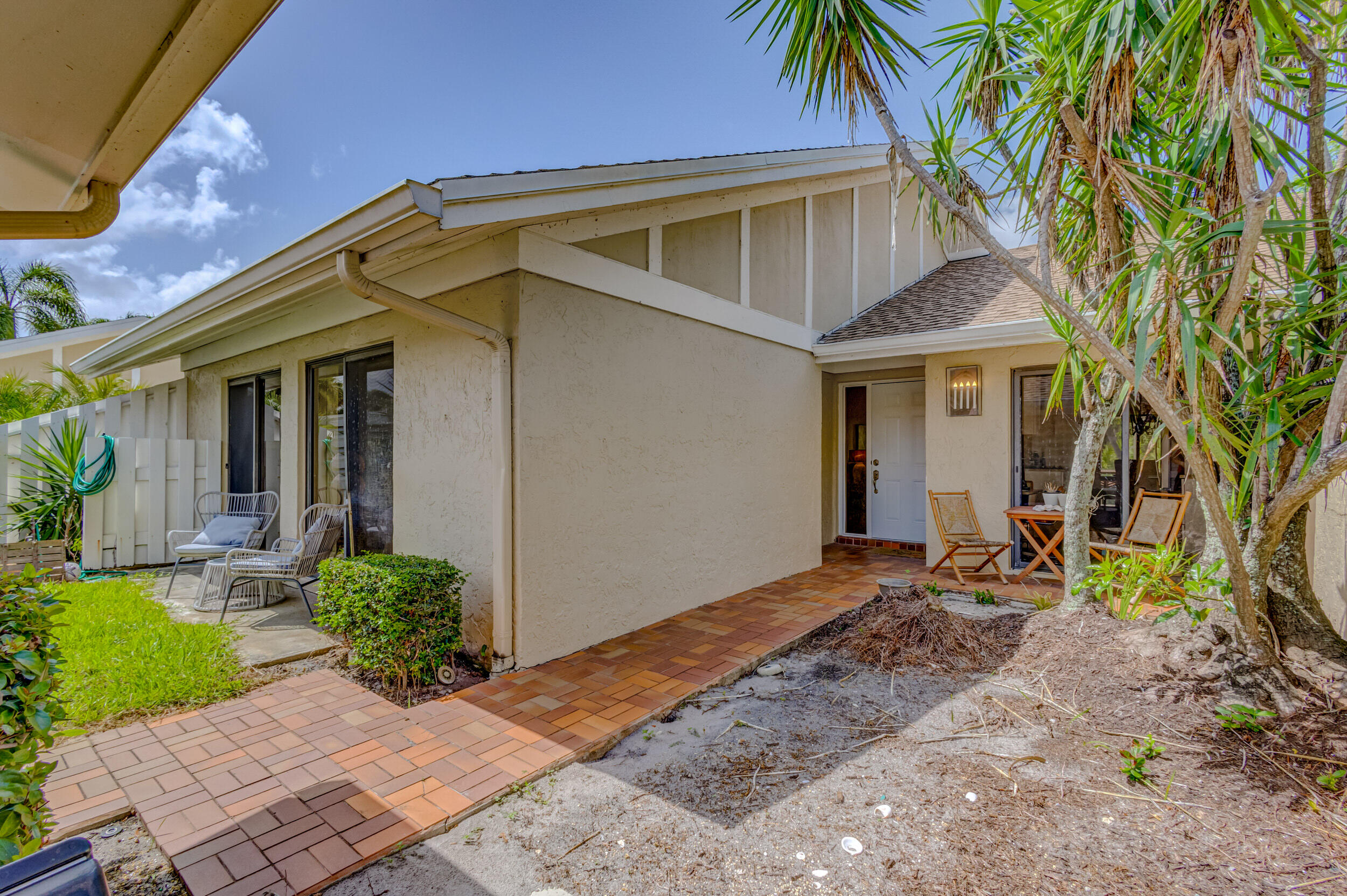 3793 Cape Pointe Circle Jupiter, FL 33477 - Photo 2 of 16 a front view of a house with garden