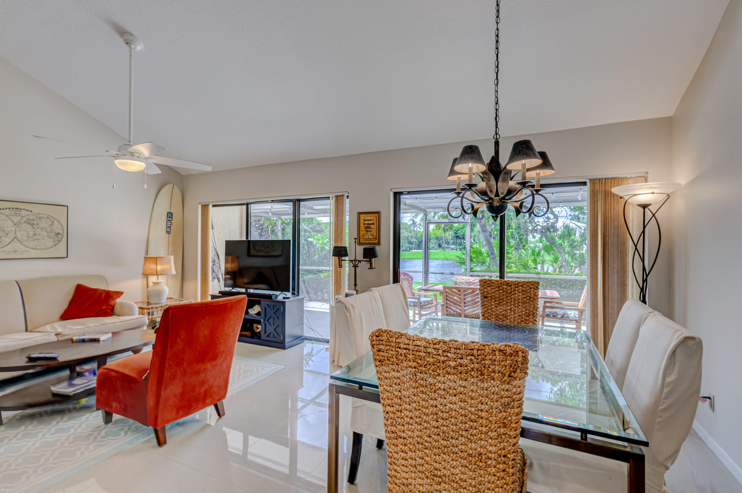 3793 Cape Pointe Circle Jupiter, FL 33477 - Photo 8 of 16 a view of a dining room with furniture wooden floor and chandelier