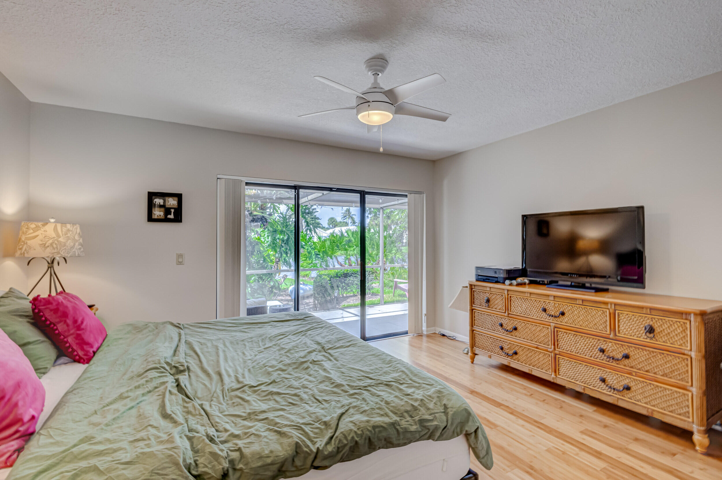 3793 Cape Pointe Circle Jupiter, FL 33477 - Photo 10 of 16 a bedroom with a bed and a flat screen tv