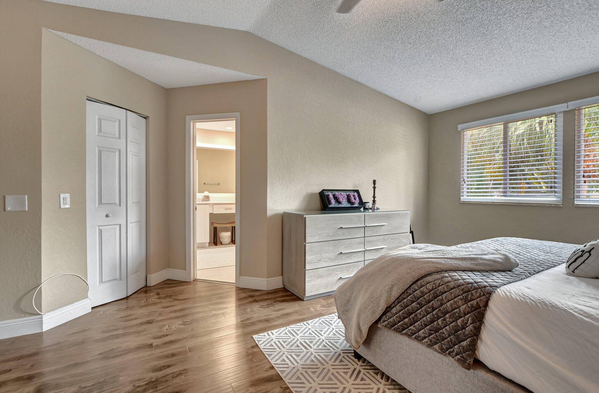 6682 Via Regina Boca Raton, FL 33433 - Photo 22 of 46 a bedroom with a bed and a window