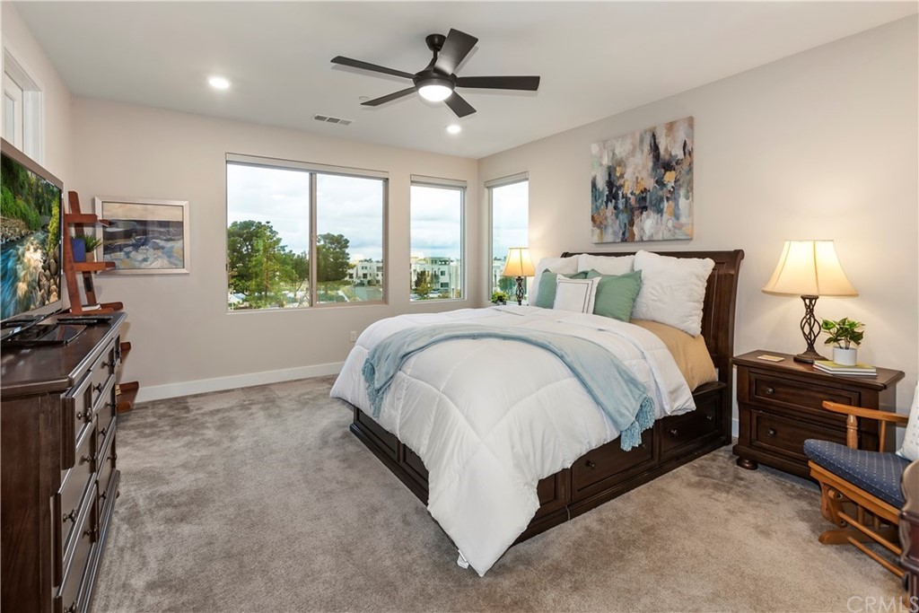 150 Catalyst Irvine, CA 92618 - Photo 11 of 25 a spacious bedroom with a bed and a chandelier