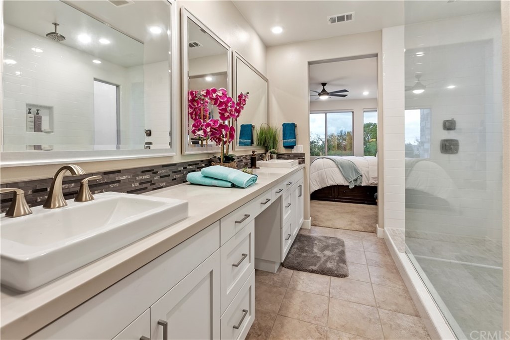 150 Catalyst Irvine, CA 92618 - Photo 12 of 25 a large white kitchen with a sink and a large mirror