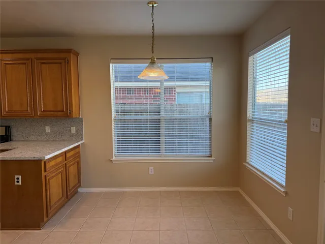 a view of wooden floor and windows in an empty room