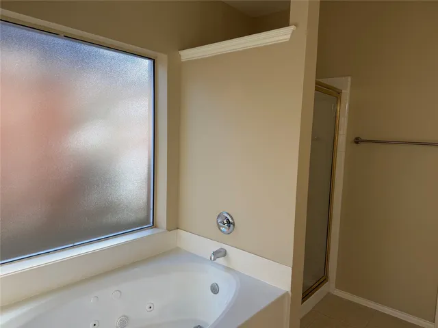 a bathroom with a double vanity sink mirror and shower