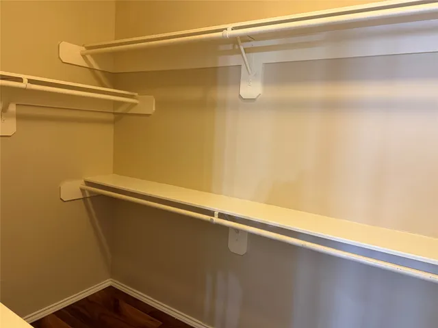 a bathroom with a toilet and a mirror