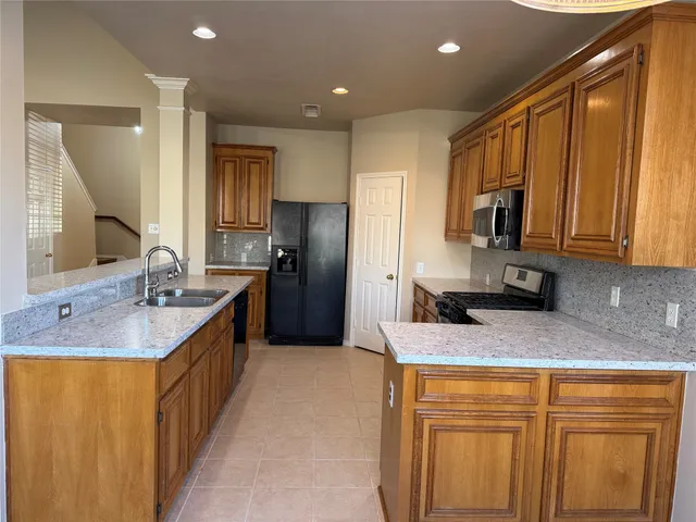 a kitchen that has a sink cabinets and a window
