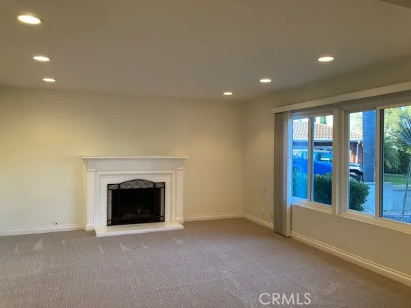 a view of an empty room with a fireplace