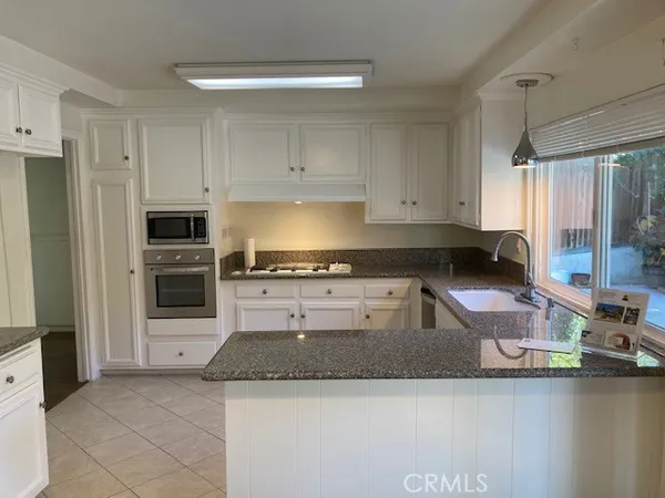 a kitchen with a stove and a refrigerator