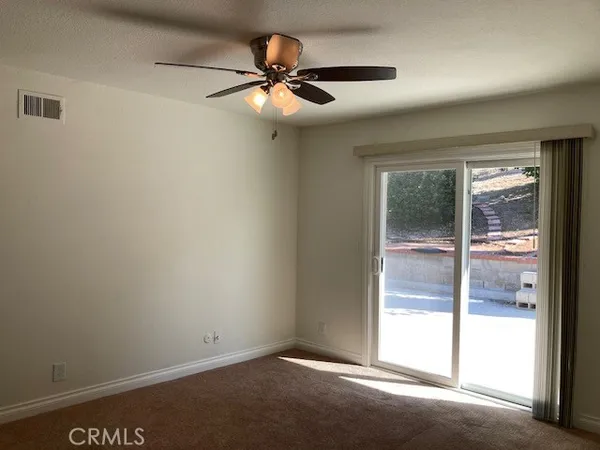 a view of room with a ceiling fan and window