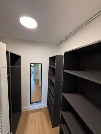 a view of walk in closet with empty racks