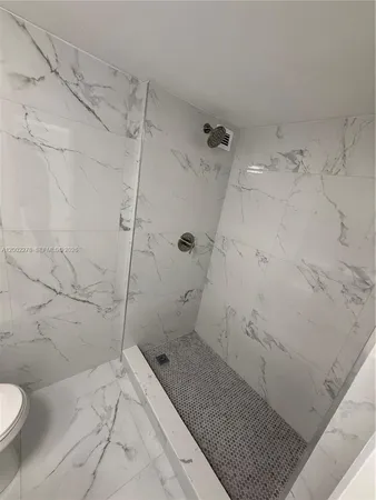 a bathroom with a sink mirror and toilet