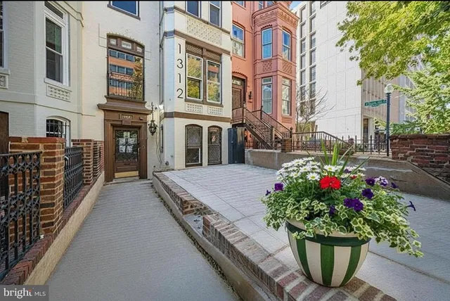 a view of a room with wooden floor and a ceiling fan