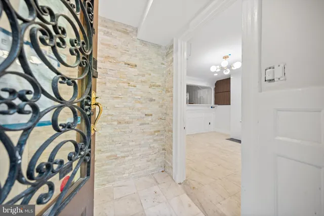 a view of empty room with a fireplace and wooden floor