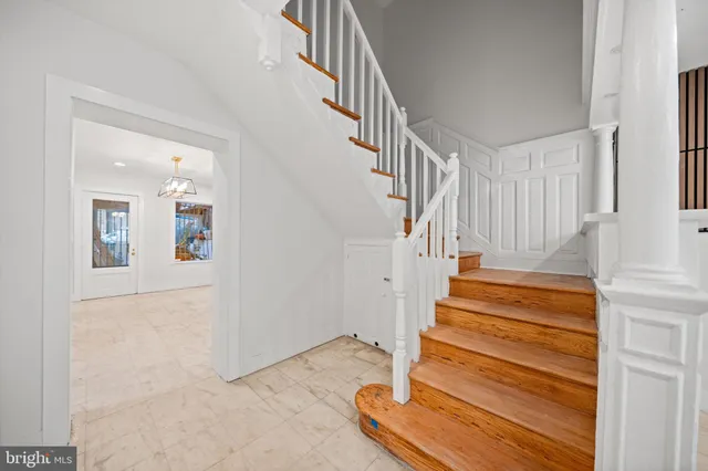 a view of an empty room with a fireplace and a window