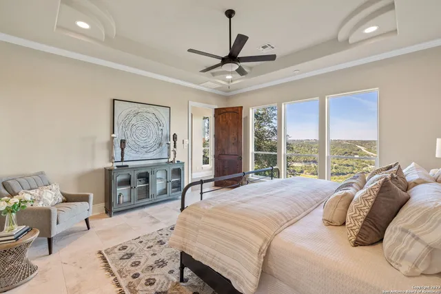 a bedroom with a bed a couch and a window