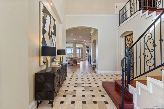 a living room with furniture a rug and a window