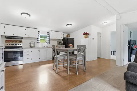 a view of a dining room with furniture and wooden floor