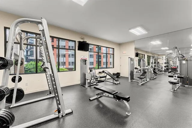 a room with gym equipment and a flat screen tv