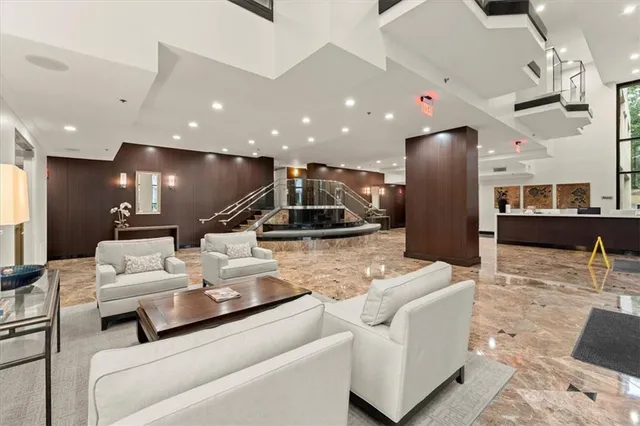 a living room with furniture and a floor to ceiling window