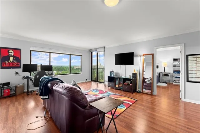 a living room with furniture and a wooden floor