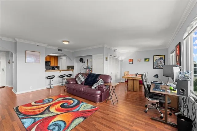 a view of a dining room with furniture a rug and wooden floor