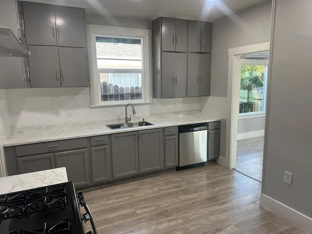 a kitchen with a sink cabinets and window