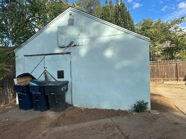 a terrace of a house with outdoor seating and trees