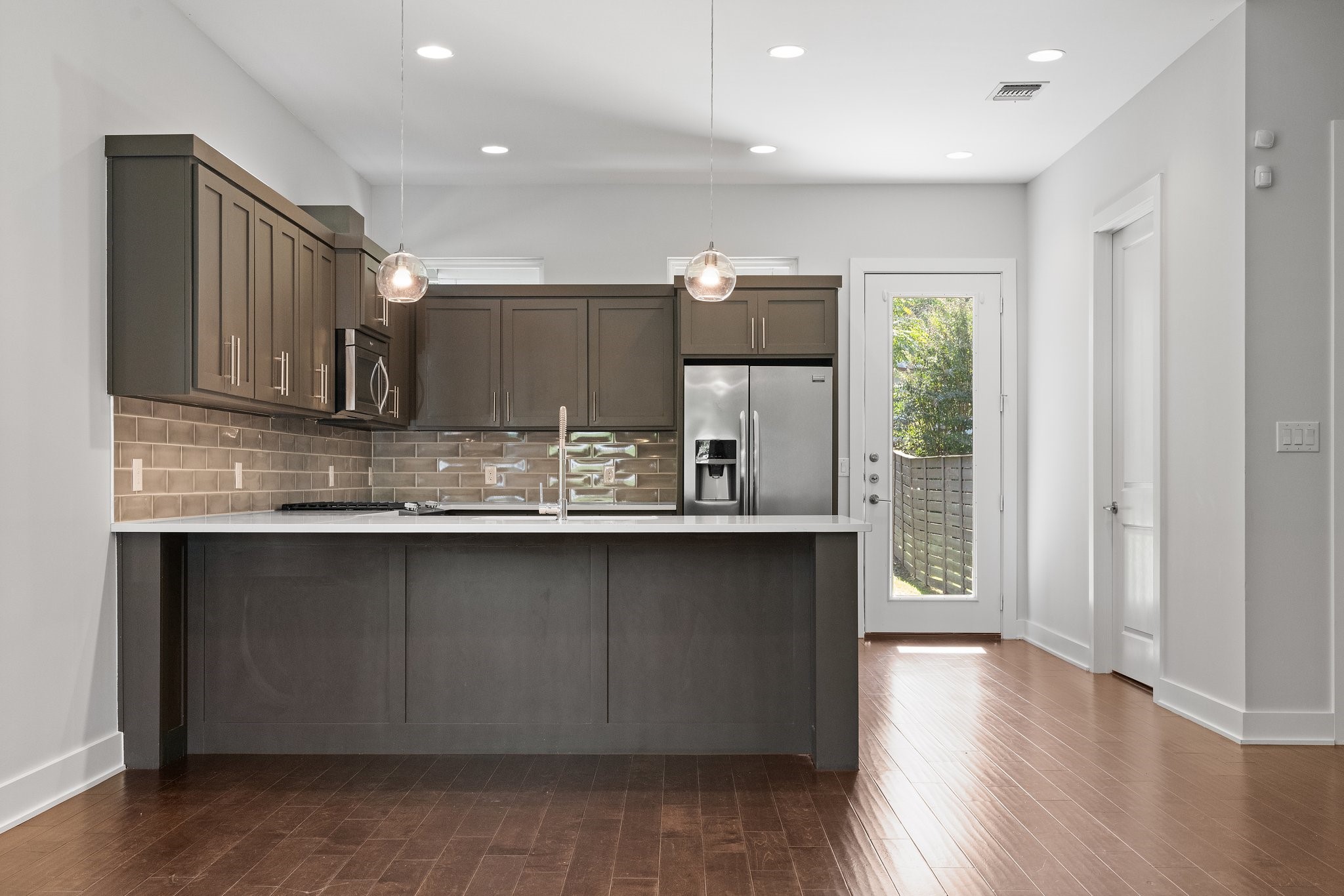 7217 Blessing Avenue, Unit A Austin, TX 78752 - Photo 5 of 22 The kitchen is fully appointment with a stainless steel refrigerator, built in microwave, and deep stainless steel sink.