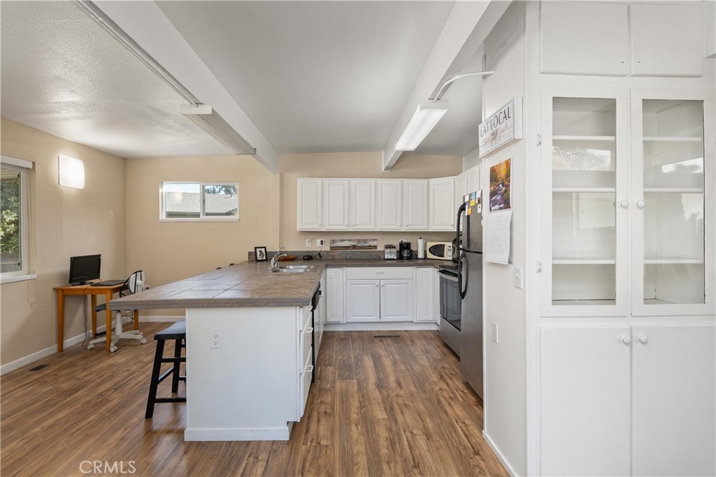5574 California Street Chico, CA 95973 - Photo 12 of 30 a kitchen with a sink a counter top space and appliances
