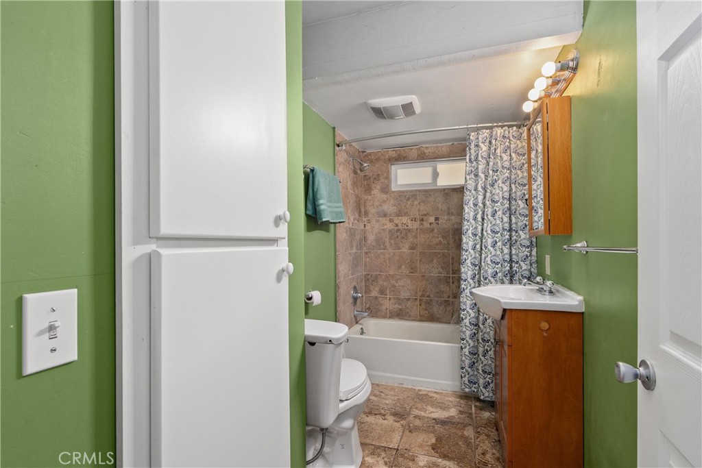 5574 California Street Chico, CA 95973 - Photo 14 of 30 a bathroom with a toilet a sink and shower