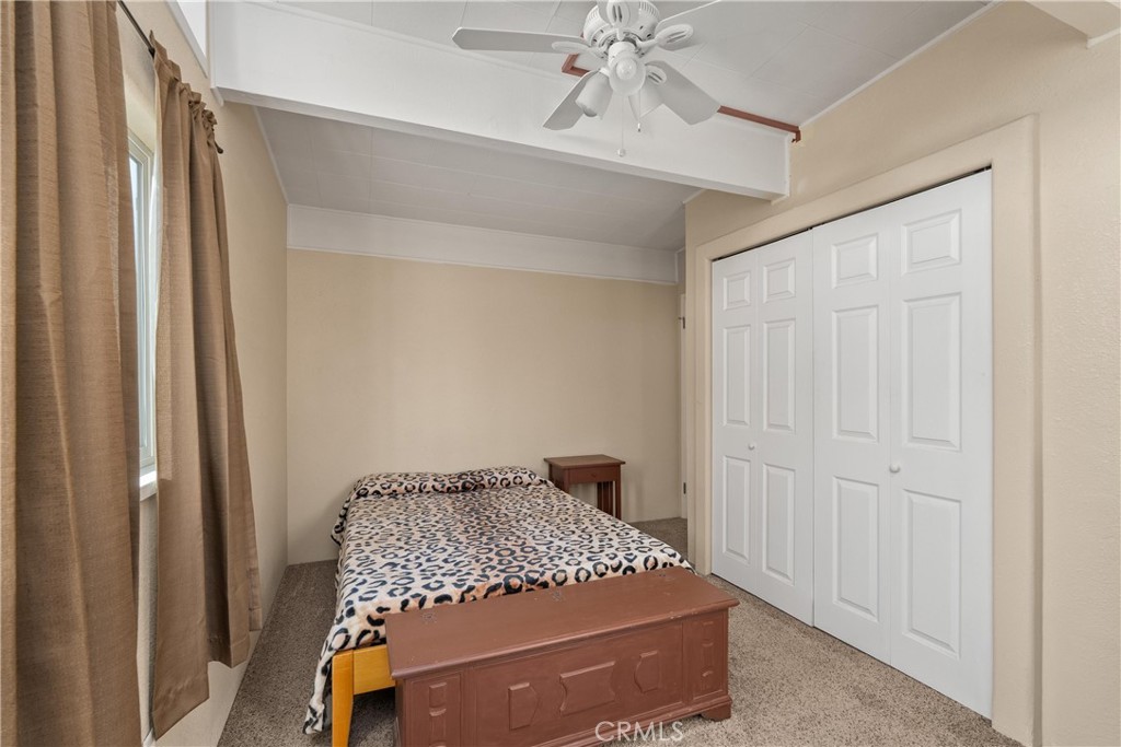 5574 California Street Chico, CA 95973 - Photo 18 of 30 a bedroom with a bed and a chandelier fan