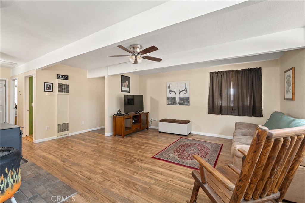 5574 California Street Chico, CA 95973 - Photo 5 of 30 a living room with furniture a flat screen tv and a table